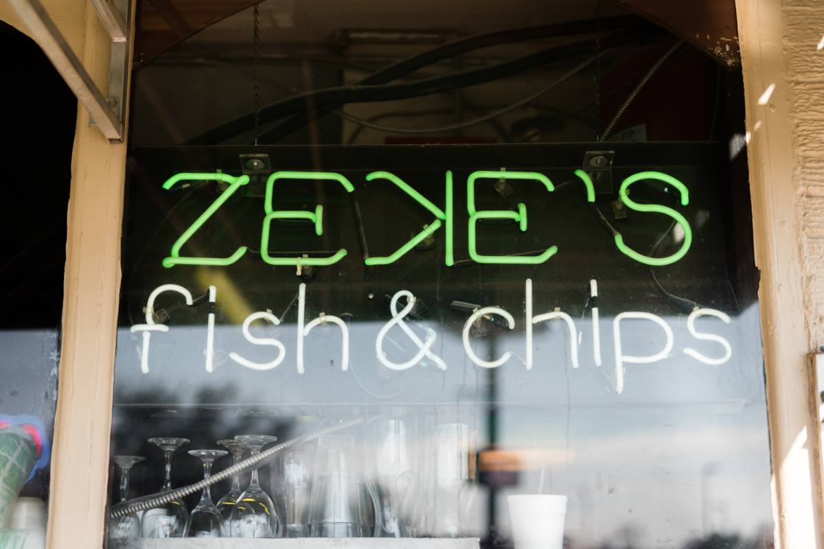 A storefront sign for Zeke's Fish & Chips